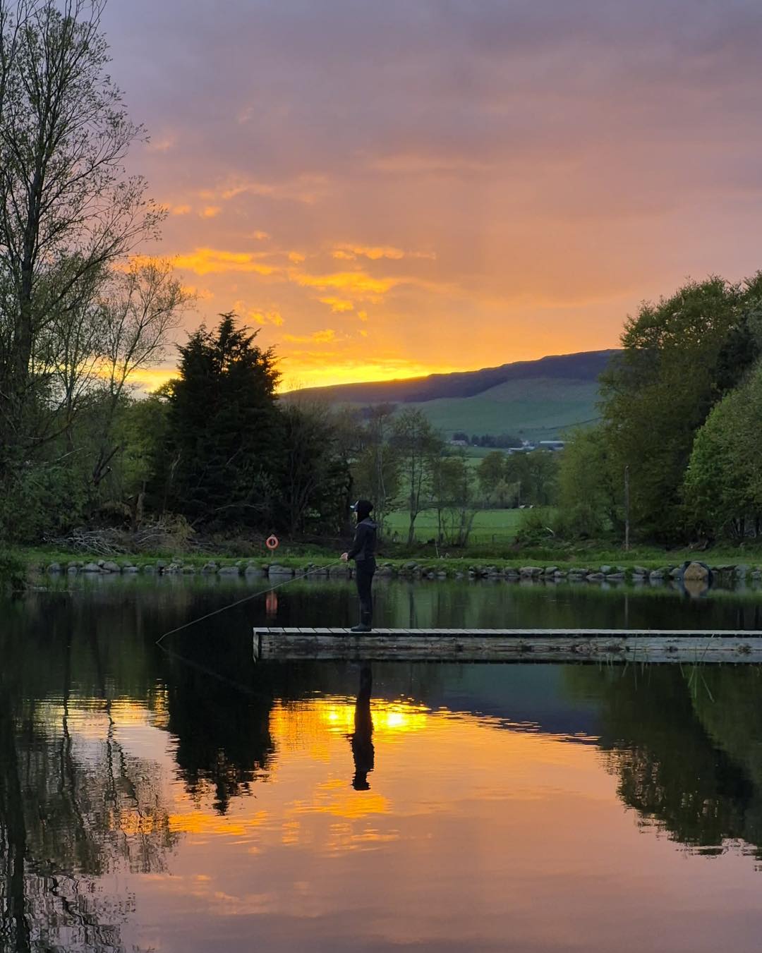 Angler on the jetty at sunset, Loch Insch